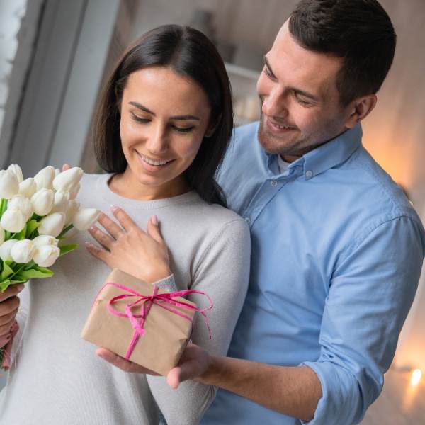 husband giving wife gift box birthday gift